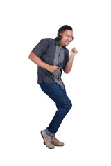 Naklejka premium Young Asian Man Listening to Music. Dancing Happily