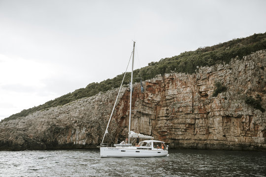 boat on the sea with cliff in background