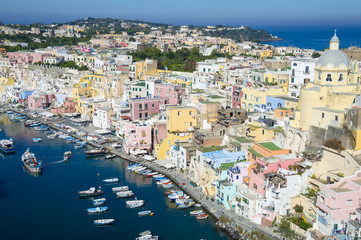 Fototapeta na wymiar Beautiful view of traditional fishing boats moored in Corricella harbour on the island of Procida, Italy.