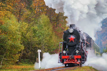 Obraz na płótnie Canvas Vintage black steam locomotive train with wagons on railway.