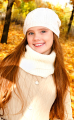 Autumn portrait of adorable smiling  little girl child  in hat