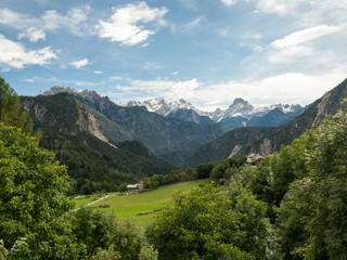 Naklejka na ściany i meble Pastures and small villages in Dolomiti, Italy. Green grass and mountains, Italy, september 2017