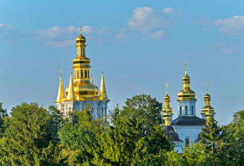 Fototapeta na wymiar Orthodox monastery, Pechersk Lavra in Kiev on the green hills of Pechersk, among green trees
