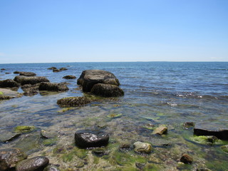 A beautiful rocky beach on a sunny day with blue sky 
