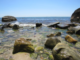 A beautiful rocky beach on a sunny day with blue sky 