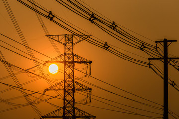 Silhouette of poles and power lines.