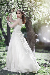 Beautiful young bride in a blooming garden