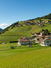 Fototapeta na wymiar Beautiful view of idyllic mountain scenery in the Dolomites with mountain village , Val di Funes, South Tyrol, Italy