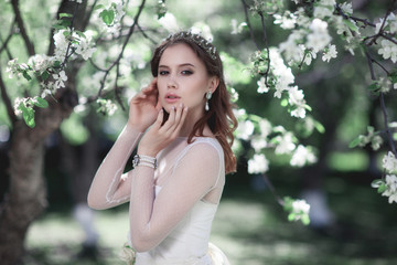 Beautiful young bride in a blooming garden