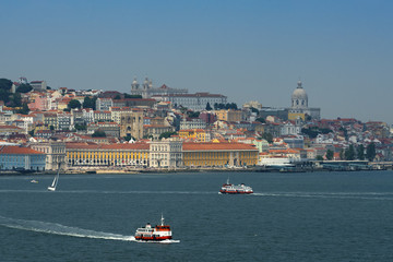 Obraz premium View of the skyline of the city of Lisbon with boats (cacilheiro) on the Tagus River; Concept for travel in Portugal and visit Lisbon