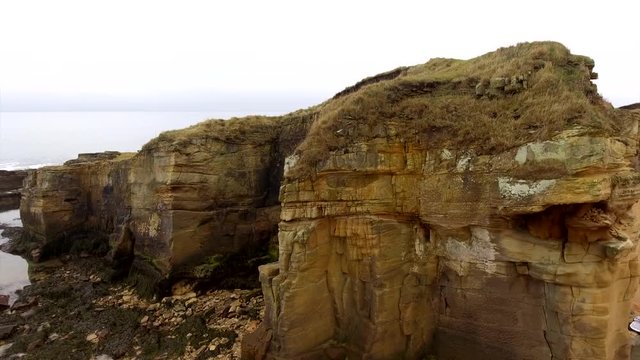 Aerial footage rising up a rock face on the Northumberland coast