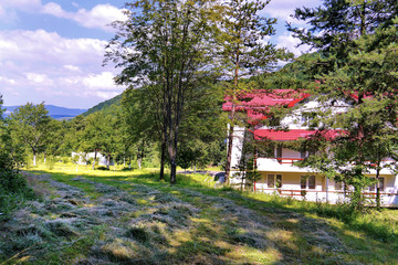 freshly mown grass near a pretty house with a tiled roof