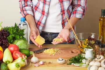 Woman cooks at the kitchen