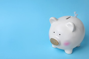 White piggy bank on color background. Money saving