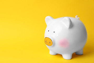 White piggy bank on color background. Money saving