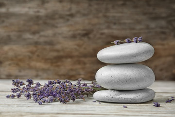 Obraz na płótnie Canvas Spa stones with lavender flowers on table