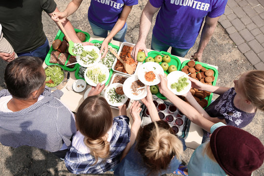 Volunteers Serving Food For Poor People Outdoors, Above View