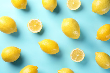 Flat lay composition with whole and sliced lemons on color background - obrazy, fototapety, plakaty