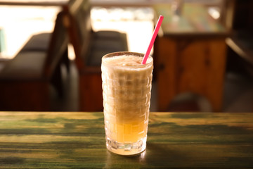 Glass with delicious cocktail on counter in cafe