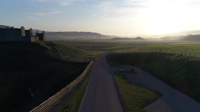 Sunrise flypast of ruined barracks in the Scottish Highlands dating back to Jacobite times.