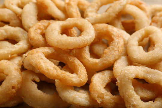 Freshly cooked onion rings as background
