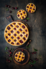 Homemade cherry pie on rustic wooden background