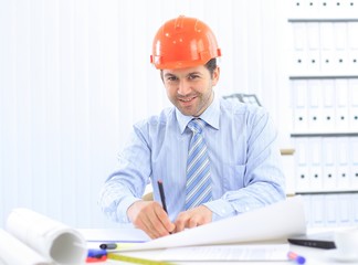Architect looking working in office at desk.