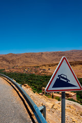 roadsign at serpentine road in atlas mountains, morocco