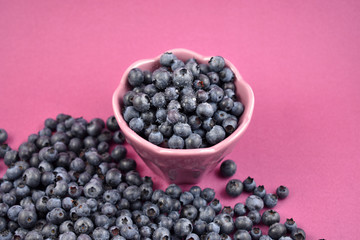 Blueberries in a bowl stock photo images. Blueberries on a purple background. Healthy summer fruit