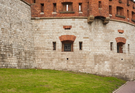 Part of the wall of an ancient castle with windows with bars. The wall of an ancient castle with windows as a texture for graphic design.