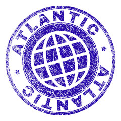 ATLANTIC stamp imprint with grunge style. Blue vector rubber seal imprint of ATLANTIC label with grunge texture. Seal has words placed by circle and planet symbol.