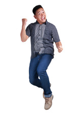 Happy Young Man Jumping and Shows Winning Gesture