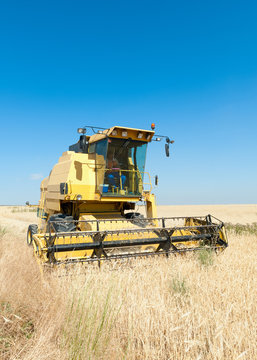 Harvester performing mowing tasks in the field.