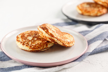 Cottage cheese pancakes, syrniki, curd fritters. Breakfast on white background.