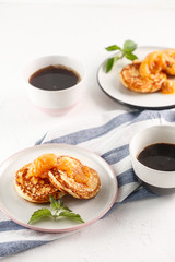 Cottage cheese pancakes, syrniki, curd fritters. Breakfast with coffee, cheesecake and apricot jam.