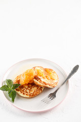Cottage cheese pancakes, syrniki, curd fritters. Breakfast on white background cheesecake and apricot jam. Flatlay. Top view. copyspace