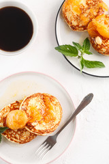 Cottage cheese pancakes, syrniki, curd fritters. Breakfast with coffee, cheesecake and apricot jam. Flatlay. Top view. copyspace