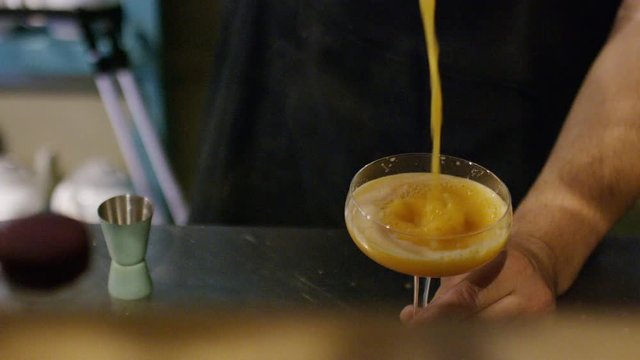Hands of a barman making a cocktail