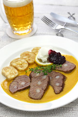 svickova na smetane ( beef in sour cream sauce) served with knedlik (bread dumpling), traditional Czech cuisine