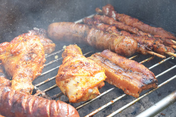 roast chicken and sausages on the grill