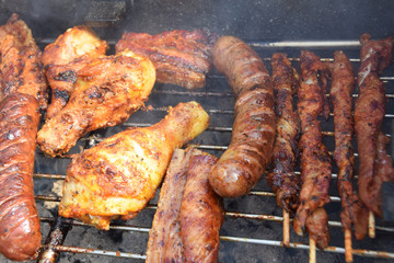 sausages, shish kebabs chicken and bacon baked on the grill