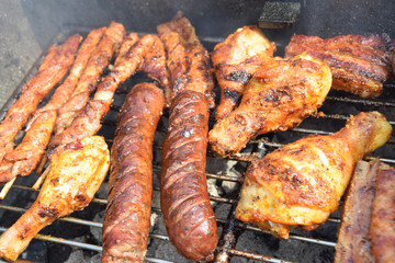 sausages, shish kebabs chicken and bacon baked on the grill
