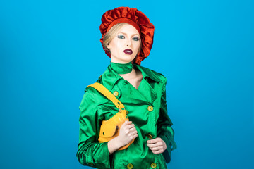 Portrait of blonde woman with evening makeup. Beauty and fashion. Fashionable girl in green suit and red beret. Fashion. Make up. Shopping concept. Girl in green suit. Bright makeup. Trendy clothes.