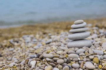 Grey pebbles: stone cairn tower, poise stones,  zen sculpture.