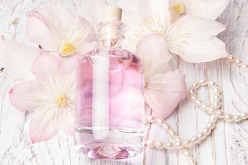 Perfume bottle and white flowers