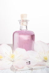Perfume bottle and white flowers