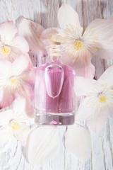 Perfume bottle and white flowers