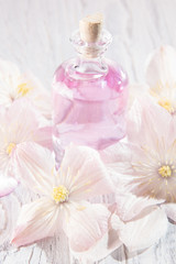 Perfume bottle and white flowers