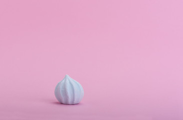Blue meringue on a pink background with space for text