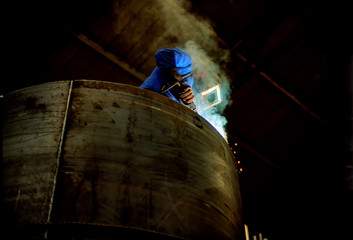 Arc Welder working on a furnace unit in a German Machine Factory.